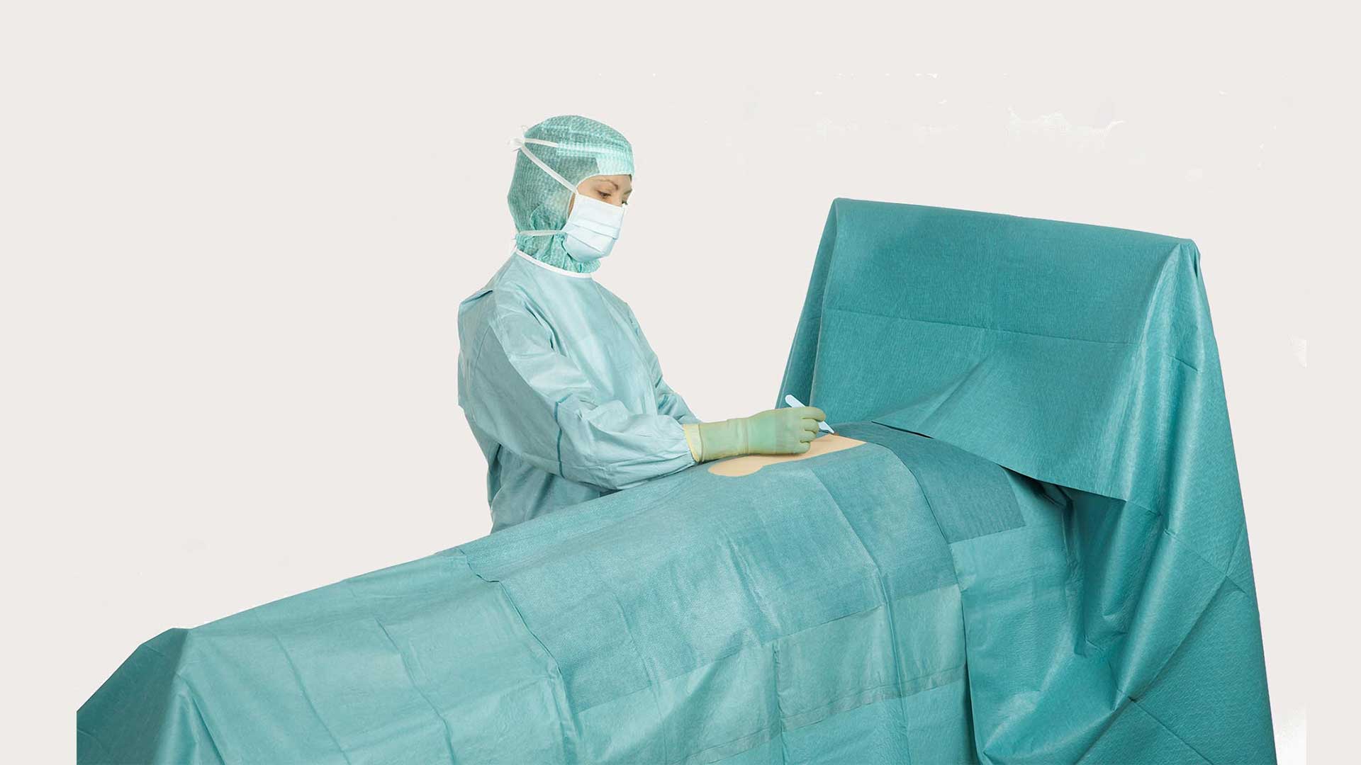 a surgeon using a BARRIER general abdominal surgery drape during an operation